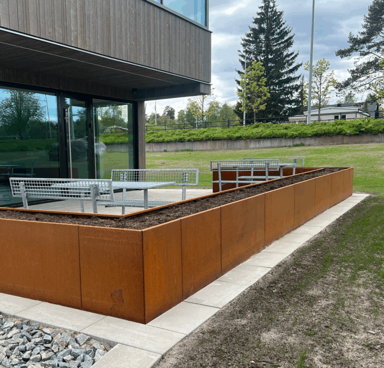 In addition to the JOS spiral staircase, Weland has also supplied a straight flight staircase with glass railing, along with a number of planters located in the courtyard (Weland Design™)